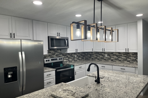 A modern kitchen with new cabinets and countertops